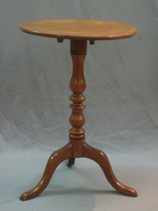 A Victorian circular walnut snap top wine table raised on pillar and tripod supports 18"