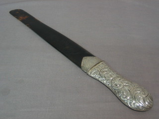 A Victorian tortoiseshell and silver mounted newspaper opener with tortoiseshell blade and embossed silver handle, London 1886