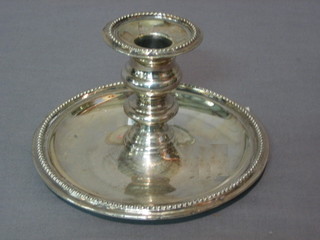 A circular silver plated chamber stick with bead work border 6"
