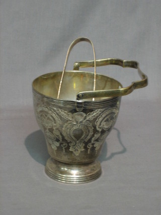 A circular engraved silver plated ice pail with swing handled together with tongs