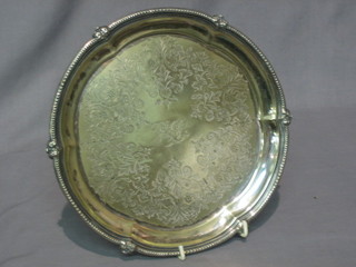 A circular engraved silver plated salver with bracketed border 9 1/2"