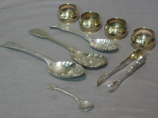 3 silver plated berry spoons, a pair of Eastern silver plated sugar tongs, an Eastern silver plated teaspoon and 4 napkin rings