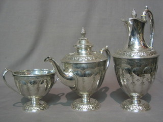 An embossed silver plated 3 piece tea service comprising teapot, hotwater jug and twin handled sugar bowl, raised on a circular spreading foot