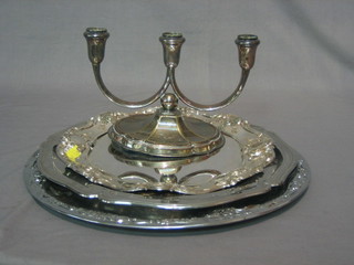 3 various silver plated platters and a silver plated 3 light candelabrum