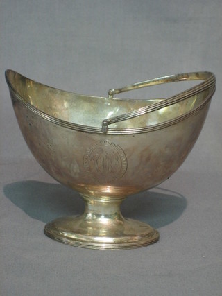 A George III silver boat shaped sugar bowl with swing handle, raised on an oval spreading foot, London 1788 8 ozs