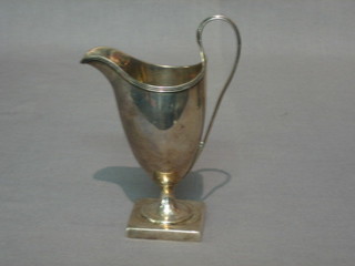 A Georgian style white metal cream jug
