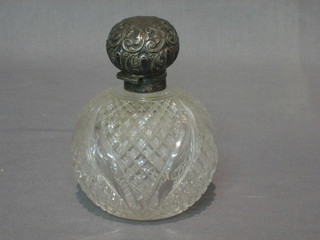 A cut glass globular shaped scent bottle with silver lid 3"