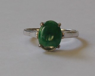 An 18ct white gold dress ring set an oval jade coloured stone (chipped)
