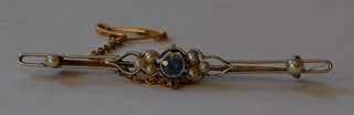 A gold bar brooch set a blue stone and pearls