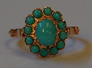 A lady's gold dress ring of cluster form set turquoise