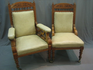 An Edwardian bleached walnut open arm chair with bobbin turned decoration upholstered in white rexine together with a similar chair raised on turned and fluted supports