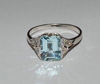 A lady's 18ct white gold dress ring set a rectangular cut aquamarine, the shoulders set 6 diamonds