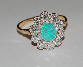A lady's 18ct gold dress ring set an oval cut opal surrounded by 10 diamonds