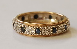 A gold eternity ring set sapphires and diamonds