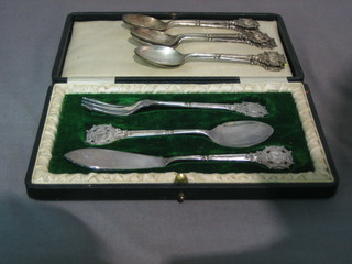 6 silver miniature rifle club teaspoons 3 ozs together with a 3 piece silver plated bread and butter set comprising pickle fork, jam spoon and butter knife all with miniature National Rifle Association badge