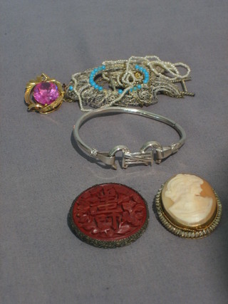 A string of seed pearls, a gilt metal pendant set a red stone, a silver gate bracelet, a cameo brooch, an Eastern brooch and a small photograph frame