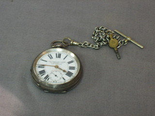 An open faced pocket watch The Veracity Lever contained in a silver case hung on a silver curb link chain