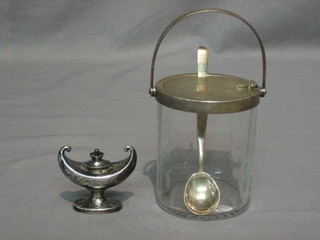 A cut glass preserve jar with patented silver hinged lid and spoon, London 1920 by the Goldsmiths & Silversmiths Co. and a silver table lighter