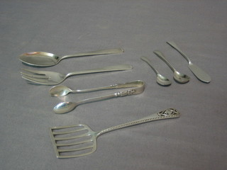 A pierced silver server, a pierced silver pickle fork, a pair of silver sugar tongs, a silver jam spoon, 2 condiment spoons and a butter knife, 4 ozs
