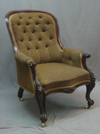 A Victorian mahogany show frame armchair upholstered in brown buttoned material, raised on cabriole supports