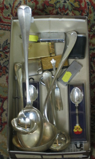 A collection of silver plated flatware and table lighters