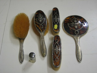 A silver and tortoiseshell backed 6 piece dressing table set comprising hand mirror, pair of clothes brushes, pair of hair brushes and watch stand, Birmingham 1932 and 1934 and a glass salts bottle with silver lid