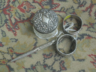 A cut glass dressing table jar with embossed silver lid 2", 2 napkin rings and a Sterling pencil 