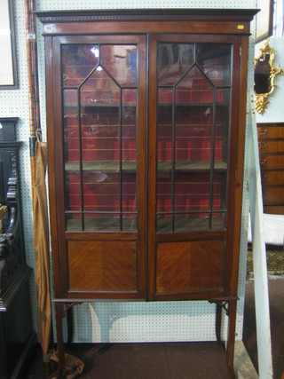 A Victorian mahogany display cabinet with moulded and dentil cornice, the interior fitted shelves enclosed by astragal glazed panelled doors raised on square tapering supports 36"