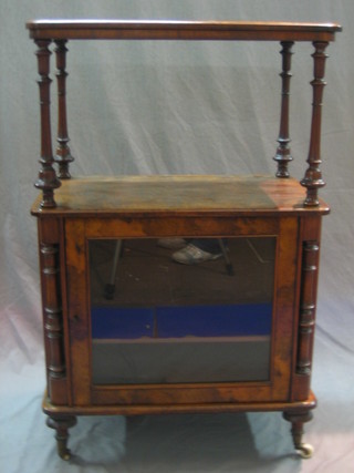 A Victorian walnut music cabinet with raised top, the cupboard enclosed by a glazed panelled door 26"