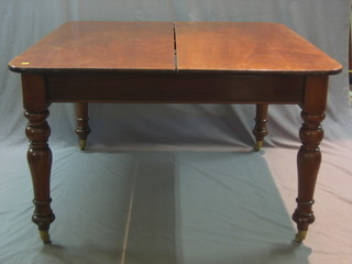A Victorian oak extending dining table raised on turned and fluted supports 56"