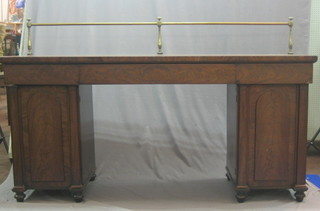 A handsome 19th Century mahogany pedestal sideboard with brass rail, the top fitted 3 drawers the pedestal enclosed by arch shaped panelled doors 78"
