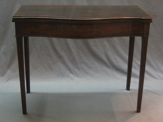 A 19th Century mahogany card table of serpentine outline, raised on square tapering supports 35"