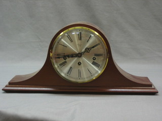 A chiming mantel clock with silvered dial and Arabic numerals contained in a mahogany arch shaped case by Rapport