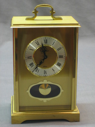 A 20th Century German 8 day striking carriage clock with silvered dial contained in a gilt case