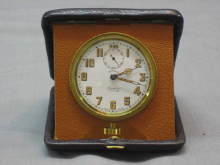 An 8 day travel clock by Mappin contained in a leather carrying case
