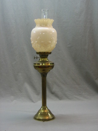 A 19th Century brassed oil lamp with reeded column, glass shade and chimney