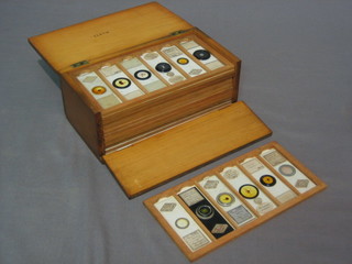 A collection of 66 Victorian glass microscope slides  contained in a wooden box with hinged lid