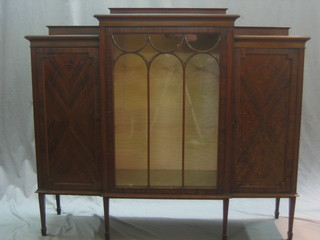 An Edwardian mahogany triple front display cabinet, the centre section fitted a cupboard enclosed by astragal glazed panelled doors, the sides flanked by 2 cupboards enclosed by a panelled door, raised on square tapering supports ending in spade feet 54"