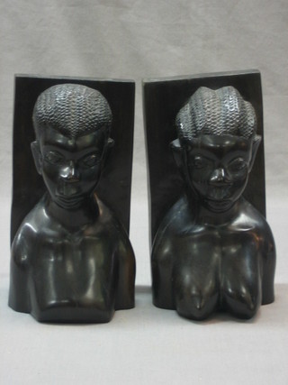 A pair of ebony book ends in the form of carved natives 10"