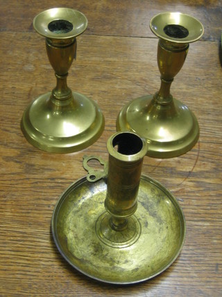 A pair of 19th Century brass stub shaped candlesticks with ejectors 5" and a do. chamber stick