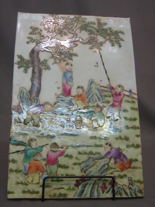A Canton famille rose porcelain panel depicting apple pickers 16" x 11"