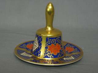 A Caverswall Derby style plate 6" and a matching hand bell  decorated by K Hancock