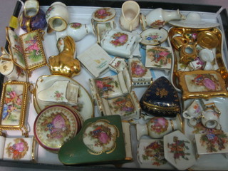 A quantity of miniature Limoges items including sofa, table, grand piano, beds, miniature tea services etc