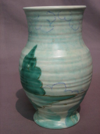 An Art Deco green glazed pottery vase decorated stylised country cottage 8 1/2"