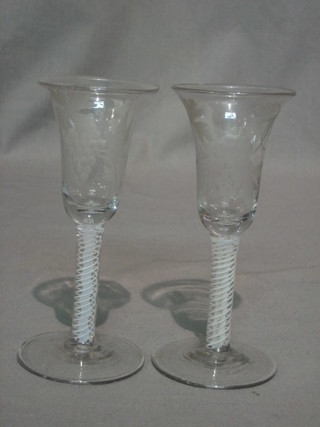 A pair of 18th Century bell shaped wine glasses with etched vinery decoration, with cotton twist stems, on spreading feet 7" (1 with slight chip to rim)