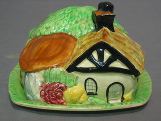 A Wadeheath pottery cheese dish in the form of a cottage 6" (crack to base)