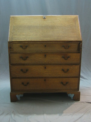 A Georgian honey oak bureau with well fitted interior above 4 long graduated drawers, raised on bracket feet 36"