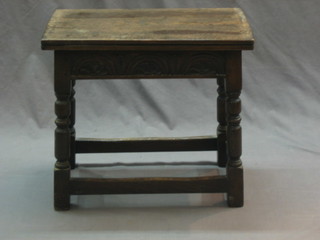 A 20th Century oak joyned stool/tea table with flip over top (top warped), raised on turned and block supports 19"