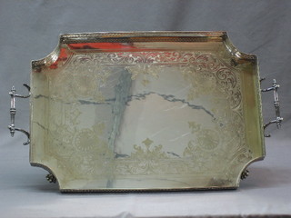 A shaped engraved silver plated tea tray with pierced gallery raised on 4 hoof feet 22"