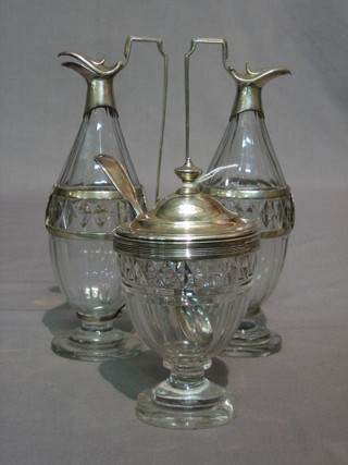A Georgian 3 piece glass and silver mounted condiment set comprising oval glass mustard pot (chip to base) and silver plated mustard spoon and 2 oil ewers (chip to base) 9"